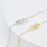 top view of two elegant necklaces featuring three detachable round charms in gold and silver